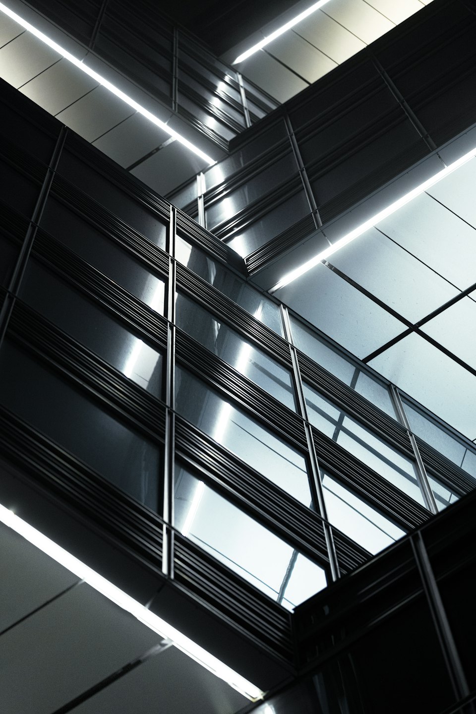 Reflective glass panels on a modern geometric building facade.